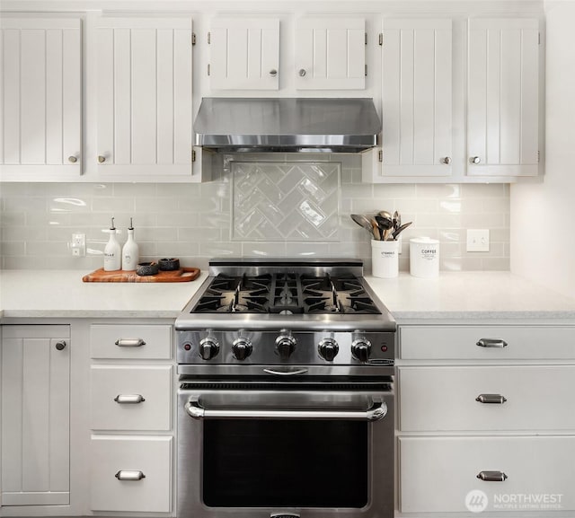 14830 Glen Acres Rd SW, Vashon, WA 98070 - kitchen with wall chimney range hood, high end range, light countertops, and decorative backsplash