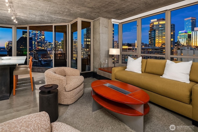 2125 1st Ave Unit 3003, Seattle, WA 98121 - living area featuring a view of skyline, concrete flooring, and a bar