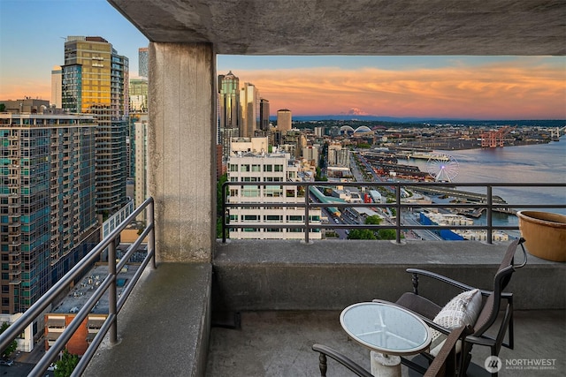 2125 1st Ave Unit 3003, Seattle, WA 98121 - balcony at dusk featuring a city view and a water view