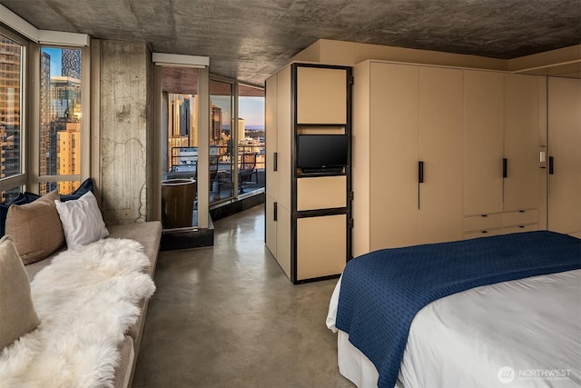 2125 1st Ave Unit 3003, Seattle, WA 98121 - bedroom featuring concrete flooring and a wall of windows