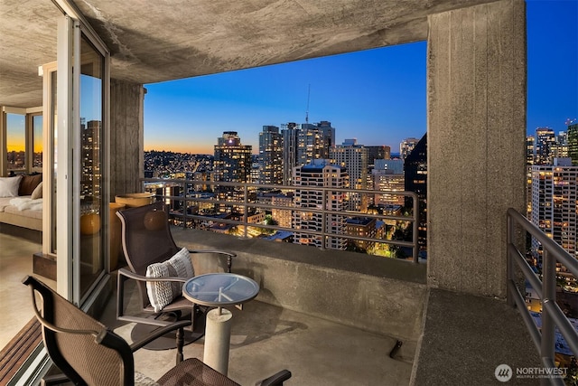 2125 1st Ave Unit 3003, Seattle, WA 98121 - balcony at dusk featuring a skyline view