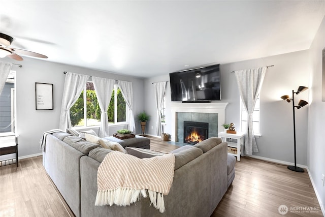 13421 Elk Ridge Rd SE, Monroe, WA 98272 - living room with a ceiling fan, a tile fireplace, and light wood-type flooring