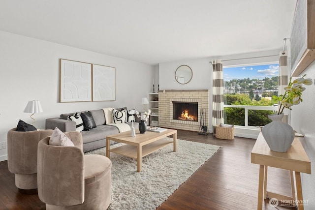 2636 22nd Ave W Unit 101, Seattle, WA 98199 - living area featuring dark wood-type flooring and a brick fireplace