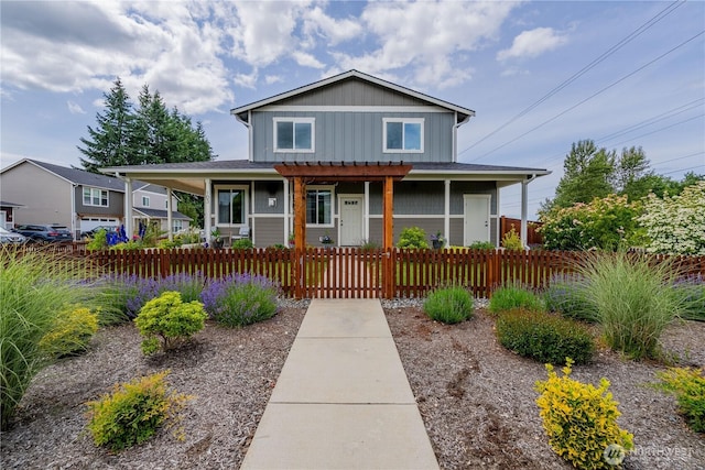 103N Trail Rd, Sedro Woolley, WA 98284 - view of front of home featuring covered porch, a fenced front yard, board and batten siding, and a pergola