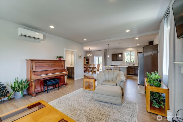 103N Trail Rd, Sedro Woolley, WA 98284 - living room featuring a wall mounted AC, light wood-style flooring, recessed lighting, and a chandelier