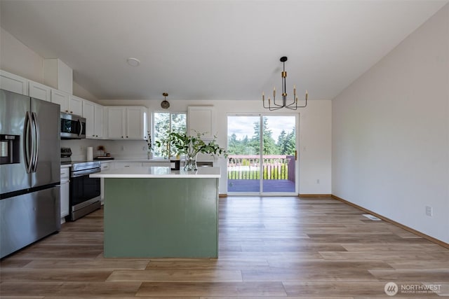 7801 144th Street Ct E, Puyallup, WA 98375 - kitchen featuring stainless steel appliances, a chandelier, white cabinetry, light countertops, and a kitchen island
