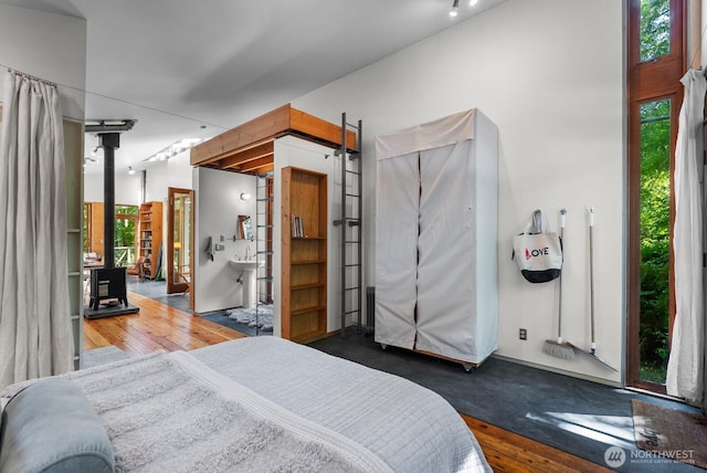 11230 Asta Ln SW, Vashon, WA 98070 - bedroom featuring wood-type flooring and a wood stove