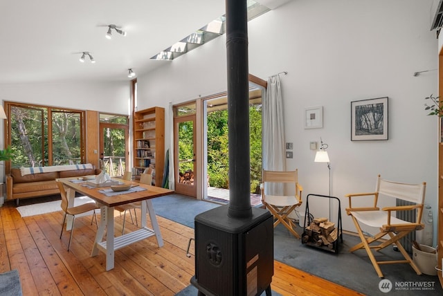 11230 Asta Ln SW, Vashon, WA 98070 - living room with a wood stove, plenty of natural light, light wood-type flooring, and high vaulted ceiling