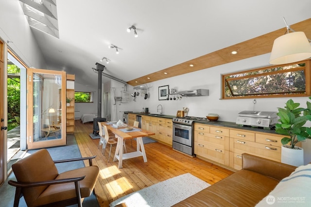 11230 Asta Ln SW, Vashon, WA 98070 - living room featuring light wood-type flooring, lofted ceiling, a wood stove, and recessed lighting