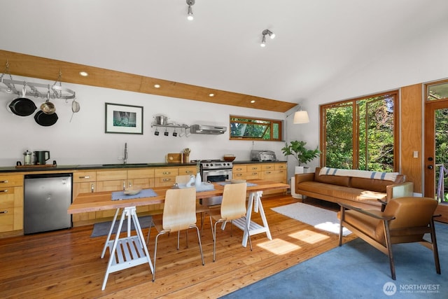11230 Asta Ln SW, Vashon, WA 98070 - kitchen featuring dishwasher, light wood-style flooring, extractor fan, high vaulted ceiling, and light brown cabinets