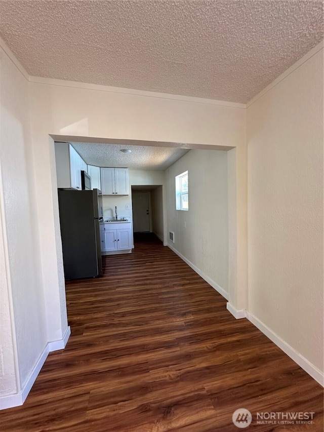 836 S Cashmere St, Wenatchee, WA 98801 - empty room with a textured ceiling, dark wood finished floors, and crown molding