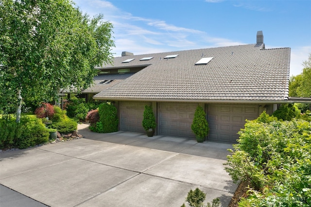 7610 Scenic Dr, Yakima, WA 98908 - view of property exterior with a tile roof, a chimney, and driveway