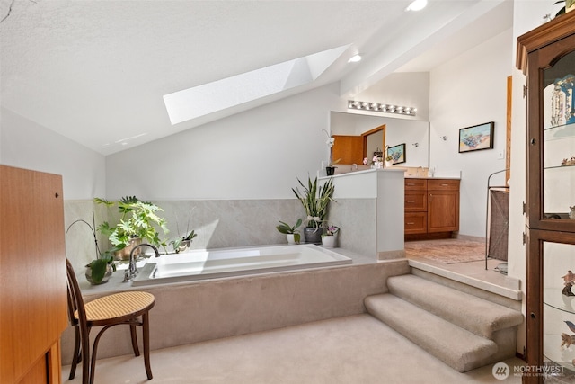 7610 Scenic Dr, Yakima, WA 98908 - bathroom featuring lofted ceiling, a skylight, a garden tub, vanity, and recessed lighting