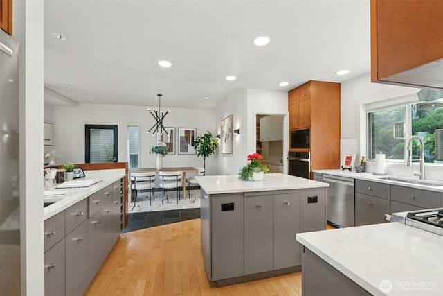 8812 NE 117th Pl, Kirkland, WA 98034 - kitchen with gray cabinetry, appliances with stainless steel finishes, light wood-style floors, and recessed lighting