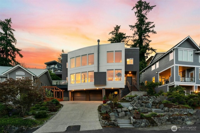 8812 NE 117th Pl, Kirkland, WA 98034 - contemporary home with stairway, driveway, a garage, and stucco siding