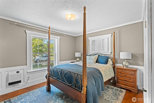 2812 Nome St, Bellingham, WA 98225 - bedroom featuring wood finished floors, a textured ceiling, ornamental molding, and wainscoting