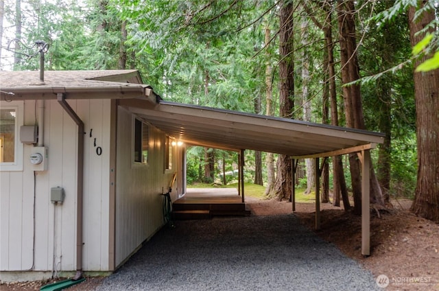 110 E Shannon Pl, Shelton, WA 98584 - view of parking / parking lot with an attached carport, driveway, and a view of trees