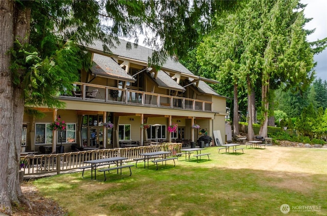 110 E Shannon Pl, Shelton, WA 98584 - rear view of house featuring a balcony, a lawn, a fire pit, and roof with shingles