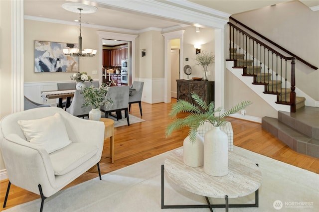 2621 NE Park Dr, Issaquah, WA 98029 - living area featuring a chandelier, stairs, ornamental molding, light wood finished floors, and a wainscoted wall