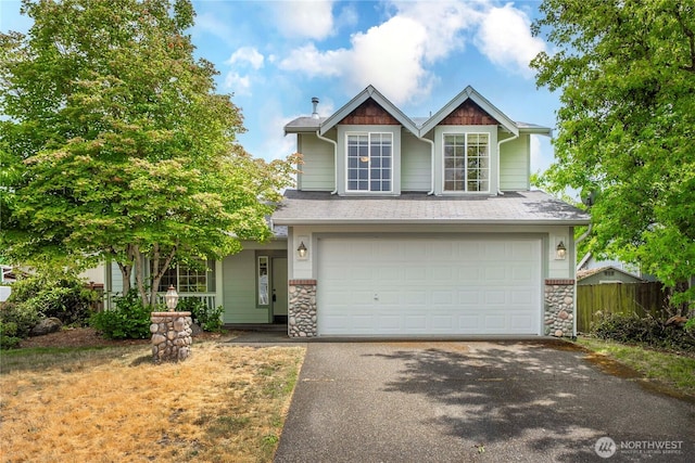 20211 86th Avenue Ct E, Spanaway, WA 98391 - view of front of property featuring asphalt driveway, an attached garage, and stone siding