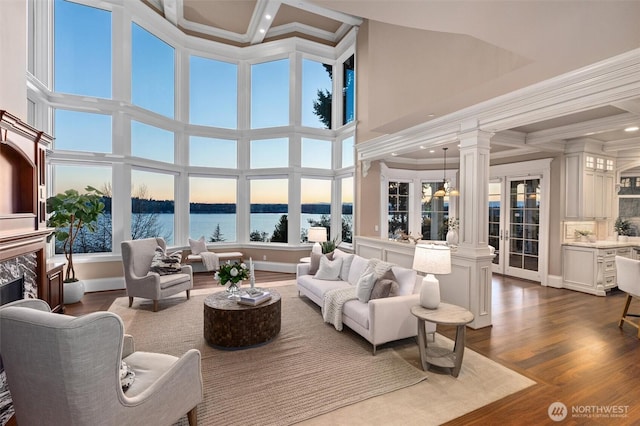 8071 W Mercer Way, Mercer Island, WA 98040 - living area with ornate columns, a water view, ornamental molding, a fireplace, and dark wood finished floors