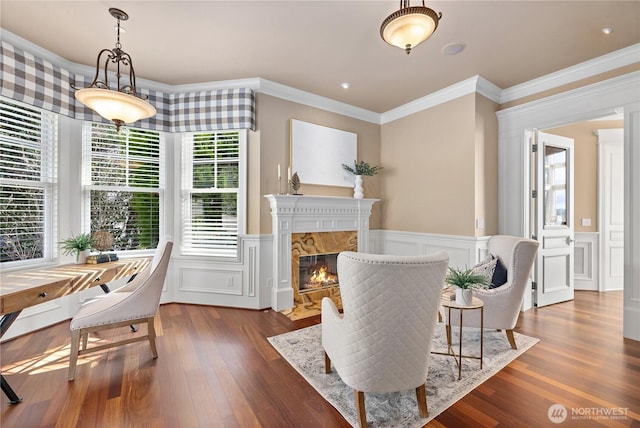 8071 W Mercer Way, Mercer Island, WA 98040 - dining space featuring crown molding, dark wood-style floors, a decorative wall, wainscoting, and a premium fireplace