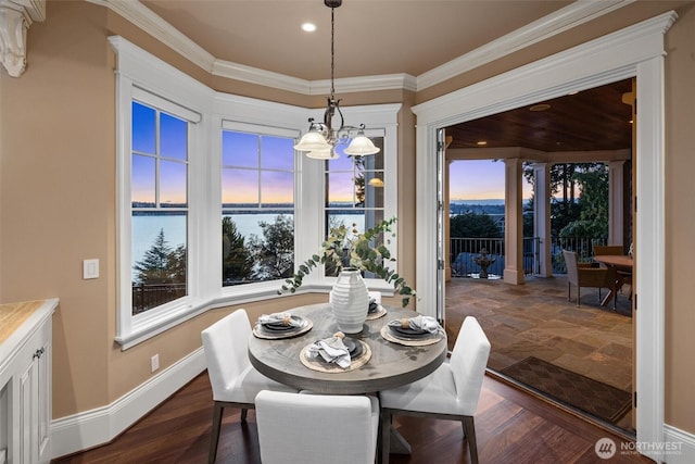 8071 W Mercer Way, Mercer Island, WA 98040 - dining area with a chandelier, a water view, dark wood-style flooring, crown molding, and recessed lighting