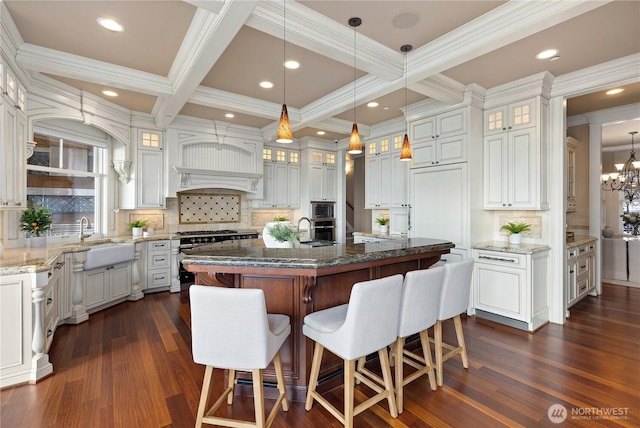 8071 W Mercer Way, Mercer Island, WA 98040 - kitchen with gas stove, a breakfast bar area, decorative backsplash, dark wood-style floors, and coffered ceiling