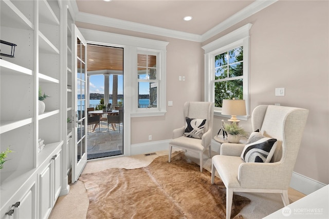 8071 W Mercer Way, Mercer Island, WA 98040 - living area with ornamental molding, recessed lighting, light colored carpet, and a water view