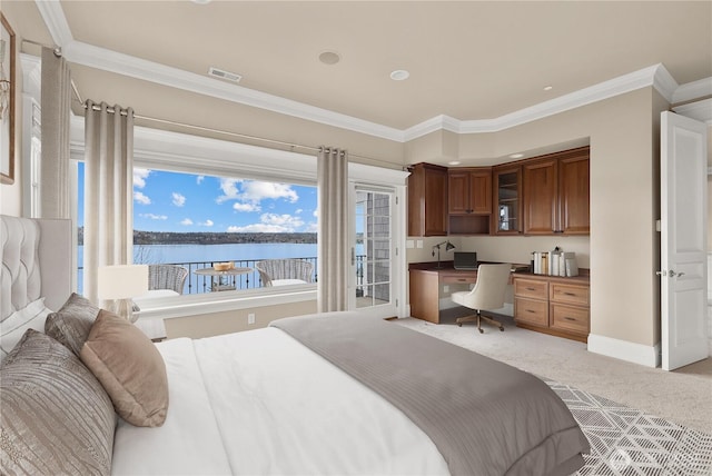 8071 W Mercer Way, Mercer Island, WA 98040 - bedroom featuring built in desk, light colored carpet, ornamental molding, and a water view