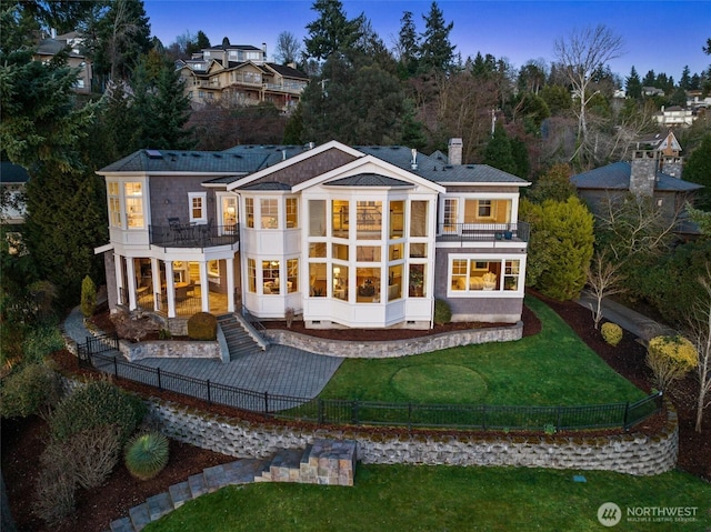 8071 W Mercer Way, Mercer Island, WA 98040 - rear view of property featuring a balcony, a fenced backyard, a chimney, and a patio