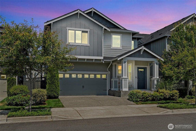 32803 Stuart Ave SE, Black Diamond, WA 98010 - view of front of house with board and batten siding, concrete driveway, and a garage