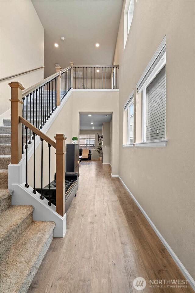 32803 Stuart Ave SE, Black Diamond, WA 98010 - foyer entrance with wood finished floors, a high ceiling, stairs, and recessed lighting