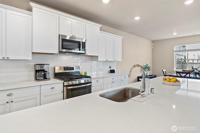 32803 Stuart Ave SE, Black Diamond, WA 98010 - kitchen featuring appliances with stainless steel finishes, white cabinets, tasteful backsplash, and recessed lighting
