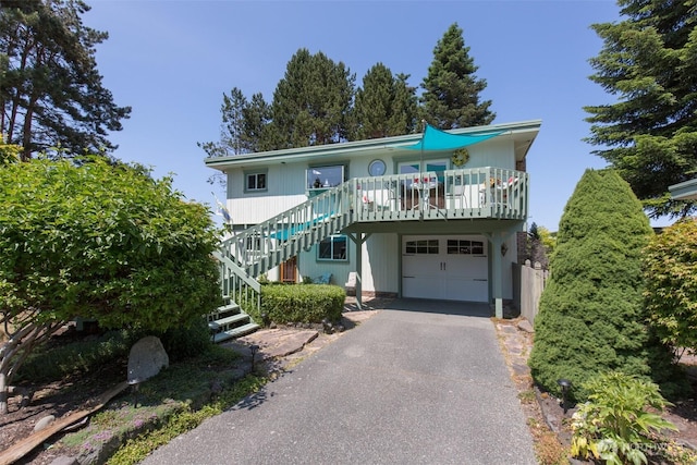 215 Amber Ln, Sequim, WA 98382 - coastal inspired home with stairway, a garage, and asphalt driveway