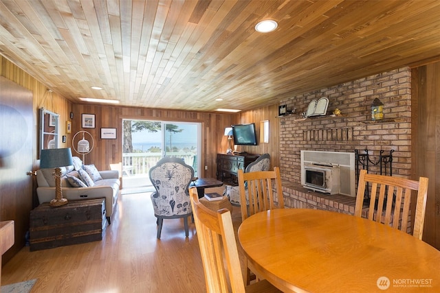 215 Amber Ln, Sequim, WA 98382 - dining room featuring wood ceiling, wooden walls, a fireplace, and wood finished floors