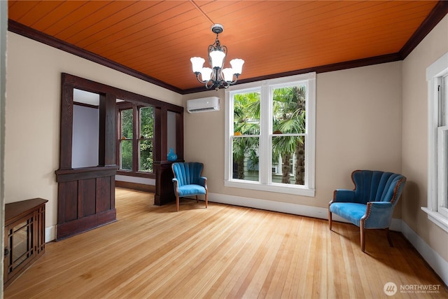 1114 5th Ave SW, Olympia, WA 98502 - unfurnished room featuring a wall mounted air conditioner, crown molding, a chandelier, wood-type flooring, and healthy amount of natural light