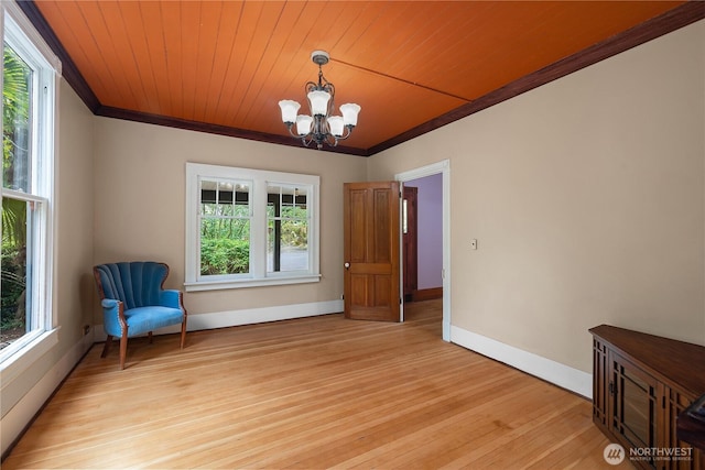 1114 5th Ave SW, Olympia, WA 98502 - unfurnished room with ornamental molding, a chandelier, light wood-type flooring, and wooden ceiling