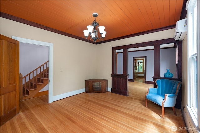 1114 5th Ave SW, Olympia, WA 98502 - unfurnished room featuring a wall unit AC, a chandelier, light wood finished floors, stairway, and wood ceiling
