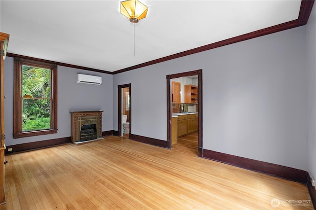 1114 5th Ave SW, Olympia, WA 98502 - unfurnished living room with an AC wall unit, light wood-style floors, ornamental molding, and a fireplace