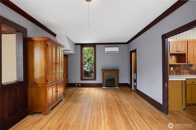 1114 5th Ave SW, Olympia, WA 98502 - unfurnished living room with a wall mounted air conditioner, light wood-style flooring, crown molding, and a fireplace