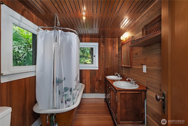 1114 5th Ave SW, Olympia, WA 98502 - full bath featuring wooden walls, healthy amount of natural light, wood finished floors, double vanity, and wooden ceiling