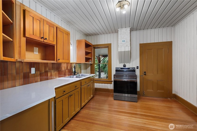 1114 5th Ave SW, Olympia, WA 98502 - kitchen featuring open shelves, stainless steel electric stove, light wood finished floors, light countertops, and brown cabinetry
