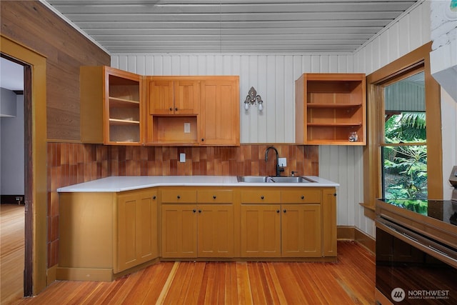 1114 5th Ave SW, Olympia, WA 98502 - kitchen with open shelves, electric range, light wood-type flooring, wooden walls, and light countertops
