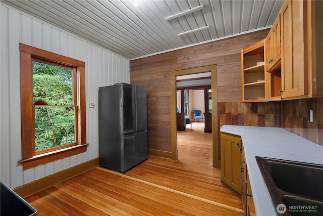 1114 5th Ave SW, Olympia, WA 98502 - kitchen with freestanding refrigerator, wooden walls, plenty of natural light, light wood-style floors, and open shelves