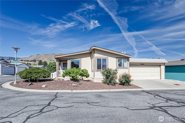 1700 Twin Peaks Dr Unit 71, Wenatchee, WA 98801 - view of front of house featuring a mountain view, driveway, and a garage