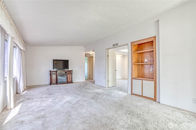 1700 Twin Peaks Dr Unit 71, Wenatchee, WA 98801 - unfurnished living room with light colored carpet and built in features