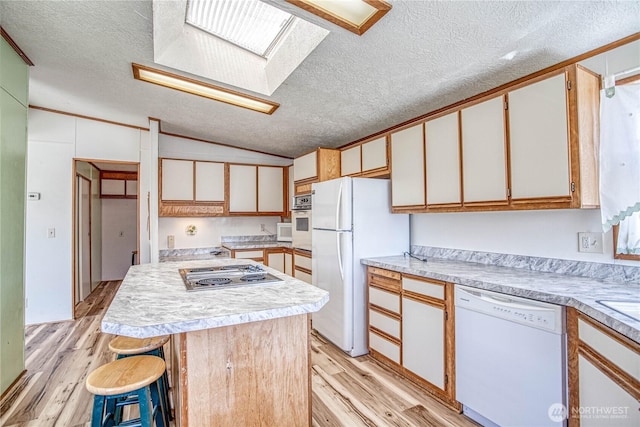 1700 Twin Peaks Dr Unit 71, Wenatchee, WA 98801 - kitchen featuring white appliances, lofted ceiling, a textured ceiling, light wood finished floors, and light countertops