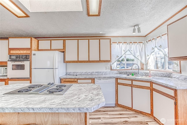 1700 Twin Peaks Dr Unit 71, Wenatchee, WA 98801 - kitchen with white appliances, light countertops, light wood finished floors, crown molding, and a textured ceiling