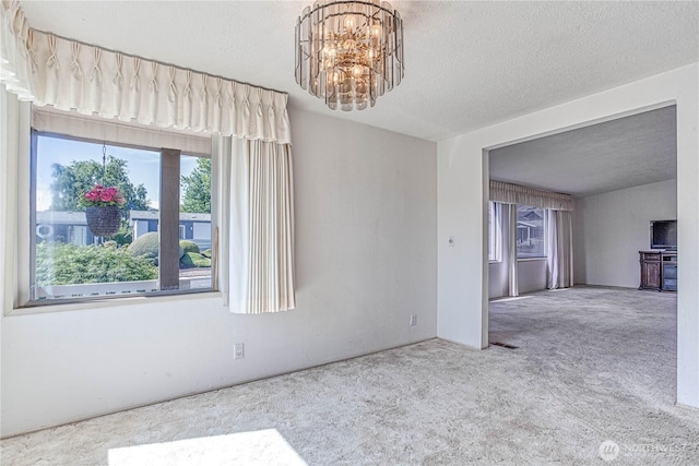 1700 Twin Peaks Dr Unit 71, Wenatchee, WA 98801 - unfurnished room with carpet floors, a chandelier, and a textured ceiling